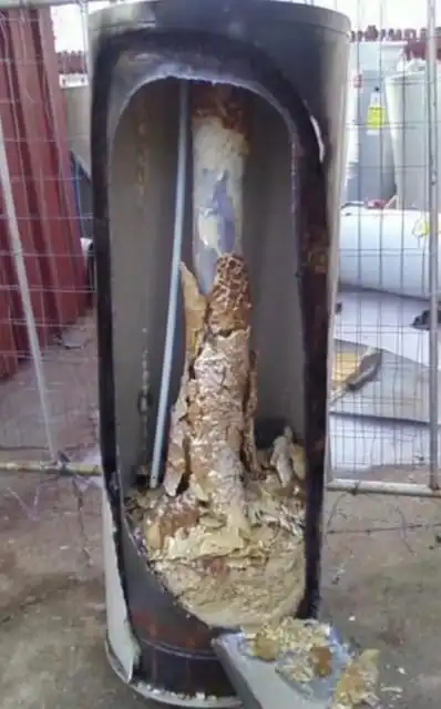 Heavy sediment buildup inside a water heater caused by hard water