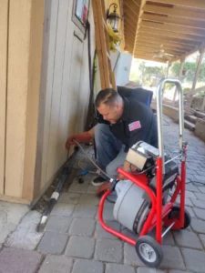 Murrieta plumbers fixing a clogged drain in the main line.
