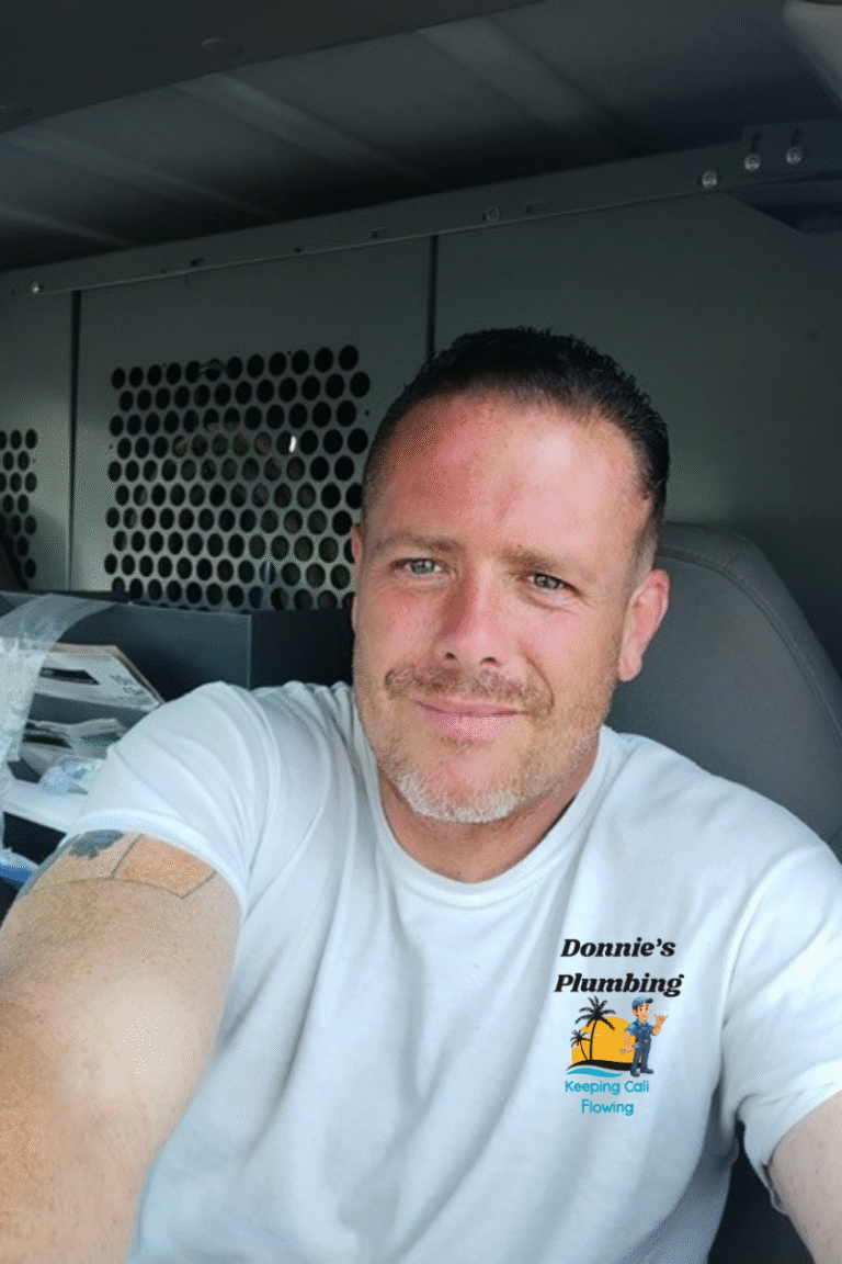 Donnie from Donnie's Plumbing sitting in his branded plumbing van in Murrieta, CA.